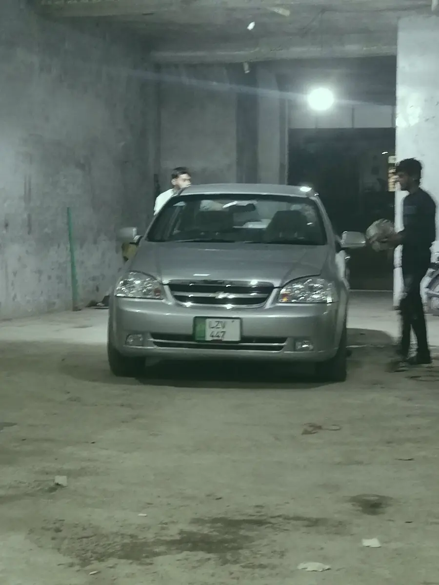 A Chevrolet Optra inside Rajab Auto Workshop
